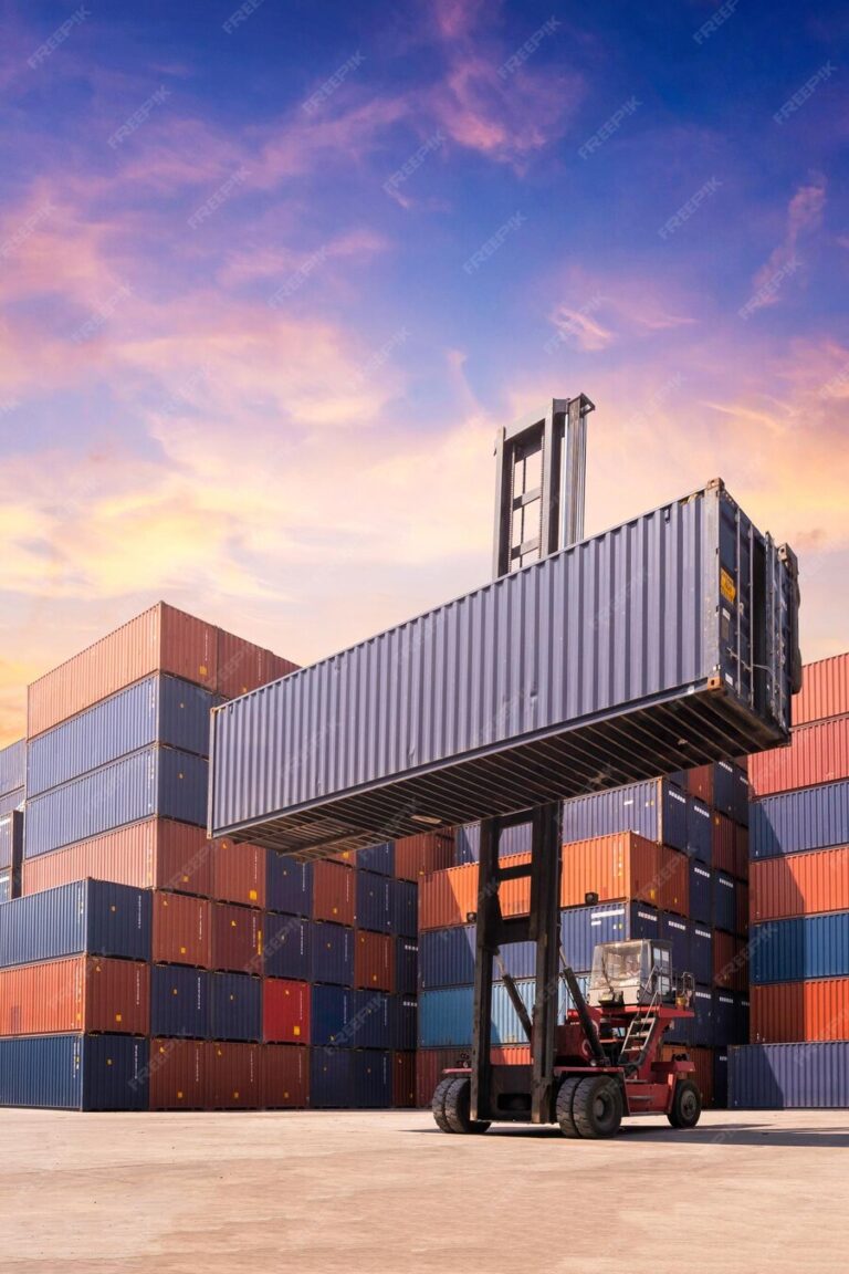 forklift-truck-lifting-cargo-container-shipping-yard-dock-yard-against-sunrise-sky-with-cargo_620652-3341